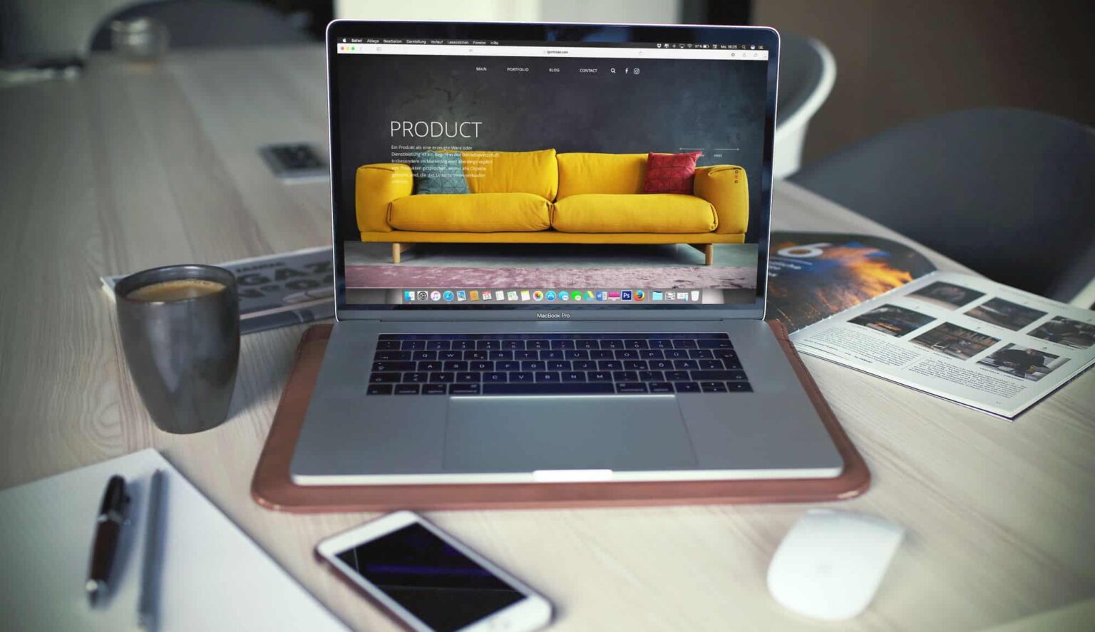 Laptop displaying furniture website on desk workspace