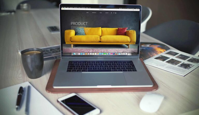 Laptop displaying furniture website on desk workspace