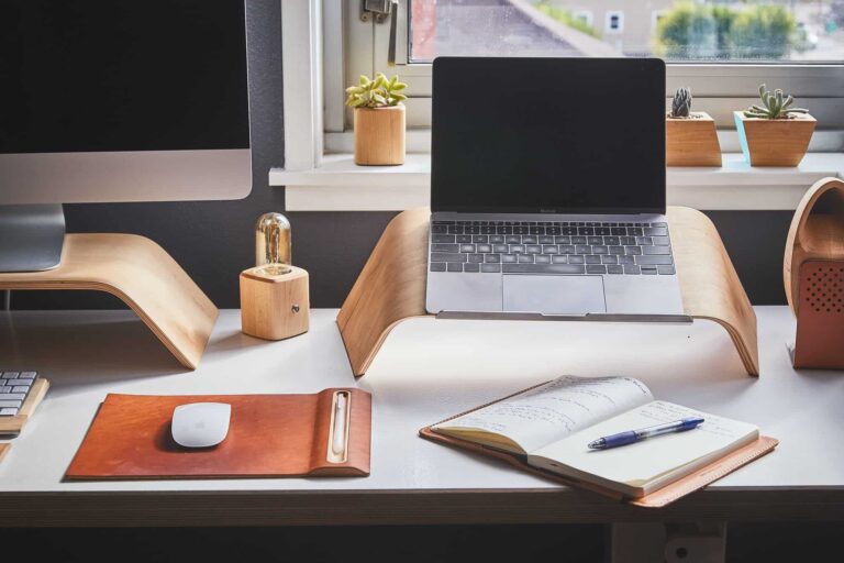 Minimalist home office desk with laptop and plants