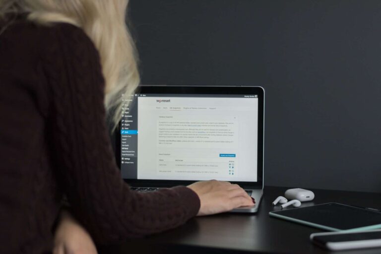 Person using laptop with WordPress dashboard open