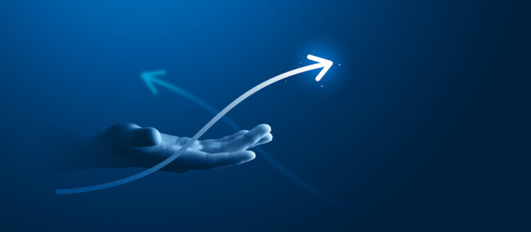 Hand holding glowing upward growth arrow