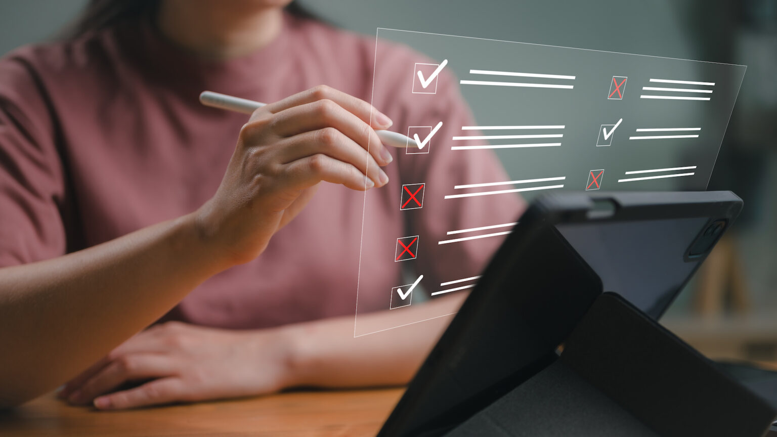 Person completing digital checklist on tablet device