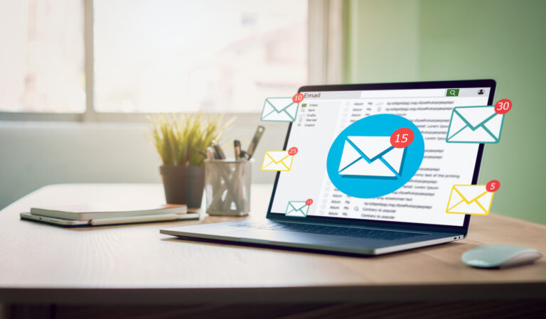 Laptop displaying email inbox with notification icons
