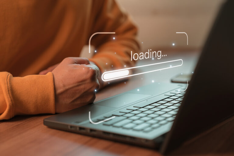 Person using laptop with loading progress bar