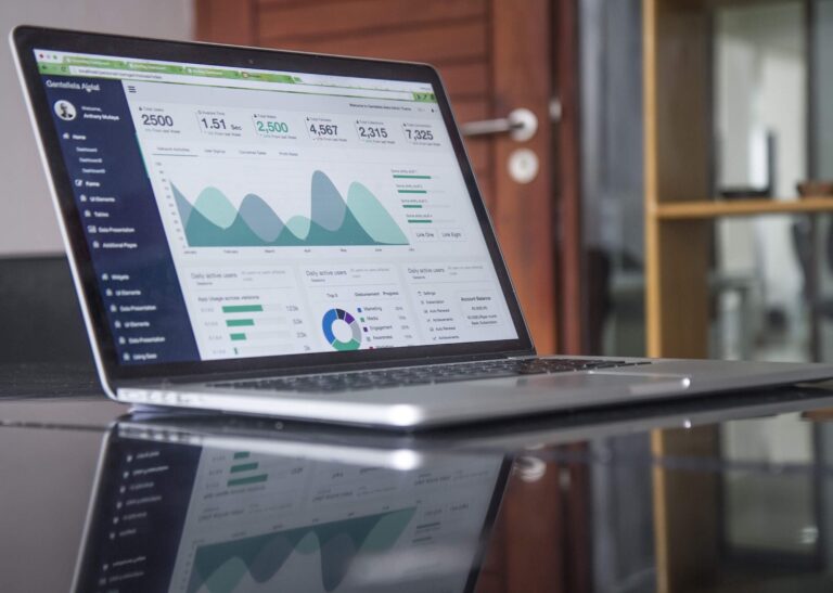 Laptop displaying analytics dashboard on office desk