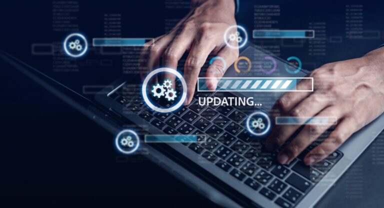 Hands typing on laptop during software update