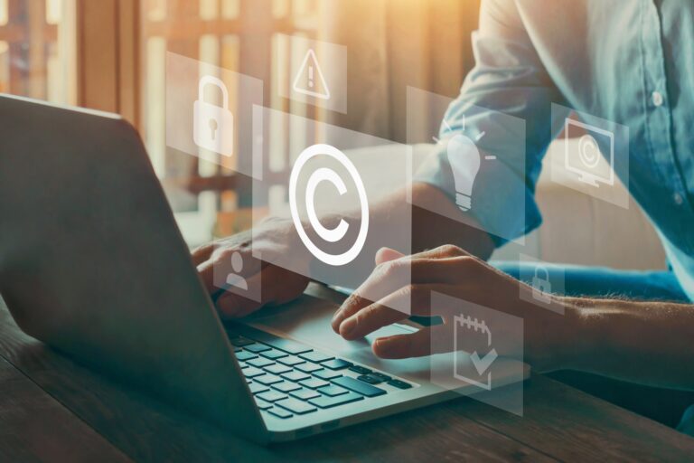 Person using laptop with copyright and security icons