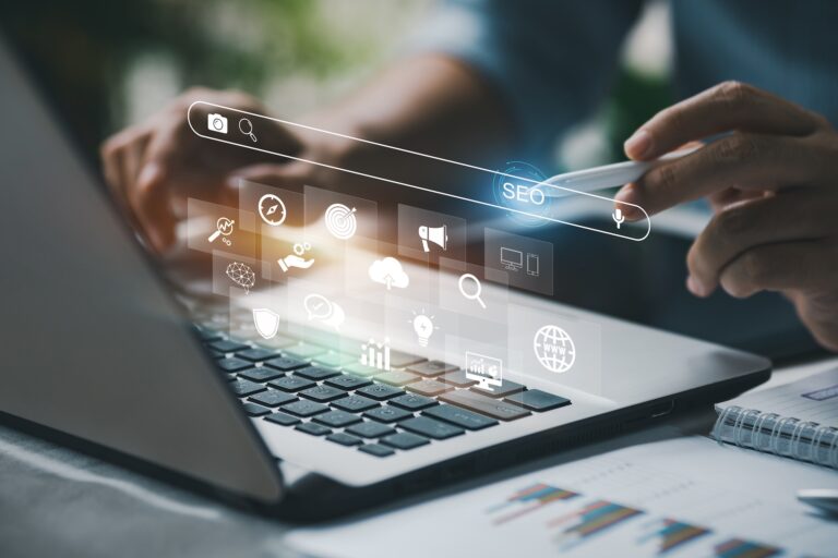 Person using laptop with SEO digital interface overlay