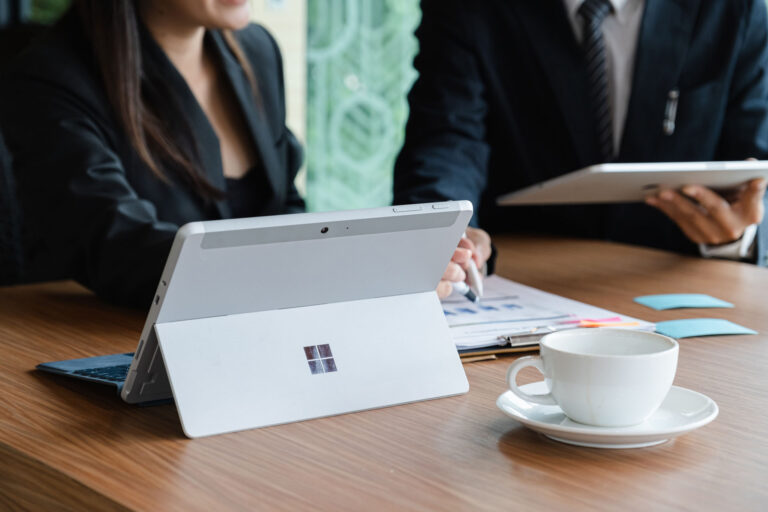 Business professionals using tablets in office meeting