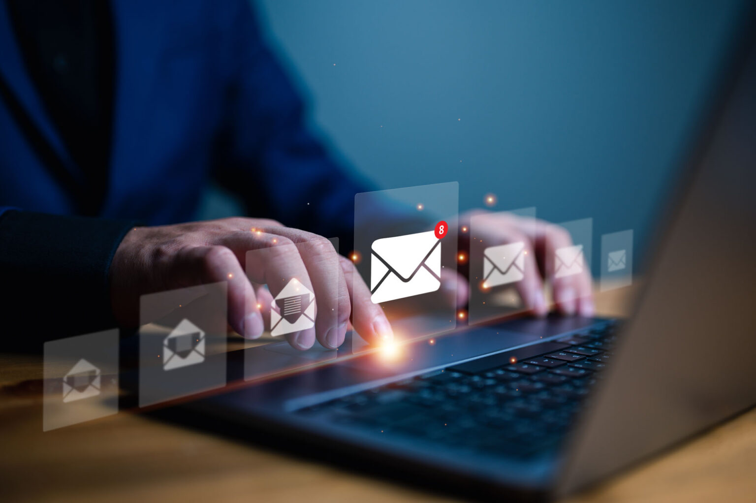 Person typing on laptop with email notifications