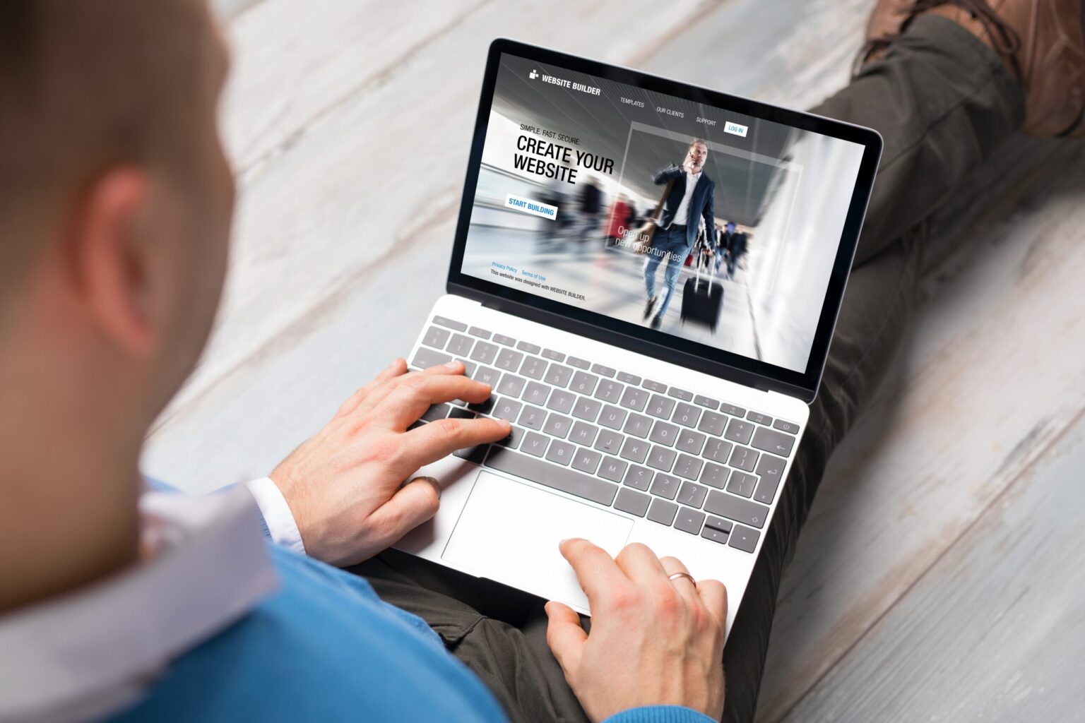 Man using laptop with website builder homepage