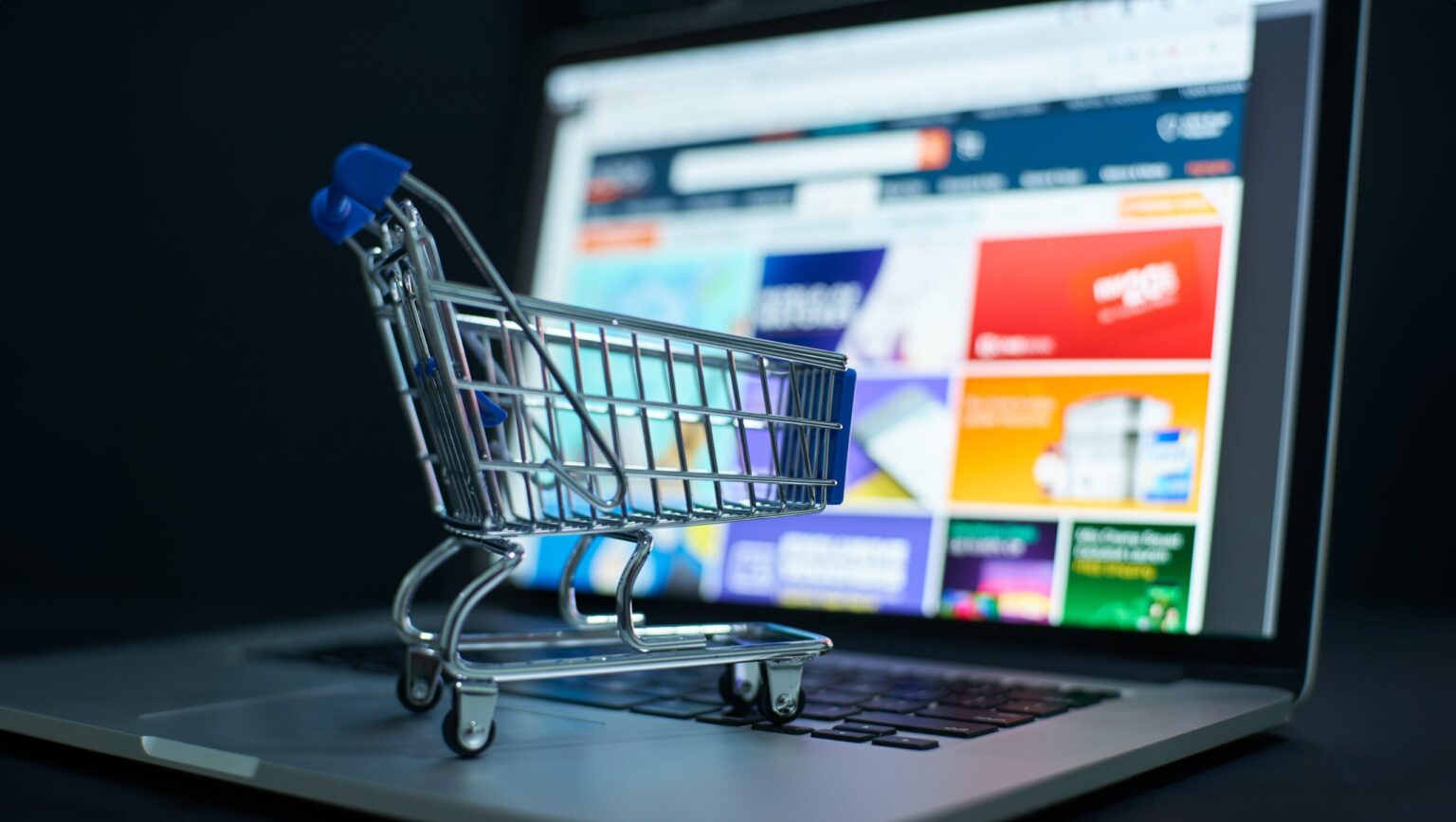 Mini shopping trolley on laptop keyboard