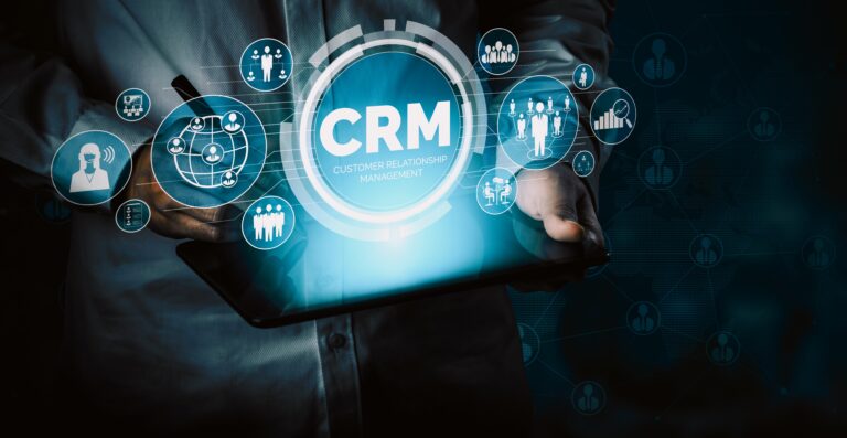 Businessperson holding tablet with CRM interface hologram