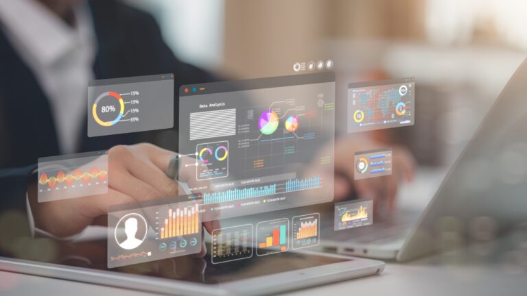 Business professional analysing digital data dashboards on tablet